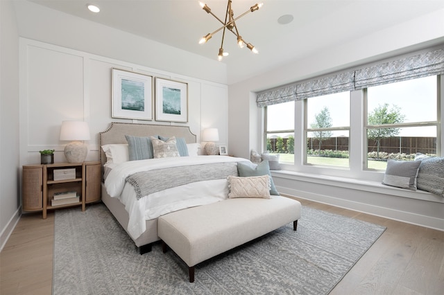 bedroom with a notable chandelier and hardwood / wood-style floors