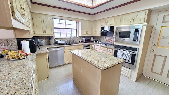 kitchen featuring a center island, wall chimney exhaust hood, sink, tasteful backsplash, and stainless steel appliances