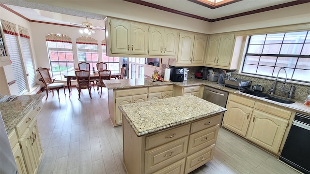 kitchen featuring backsplash, a kitchen island, ceiling fan, crown molding, and sink