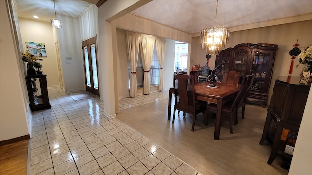 tiled dining space with a chandelier