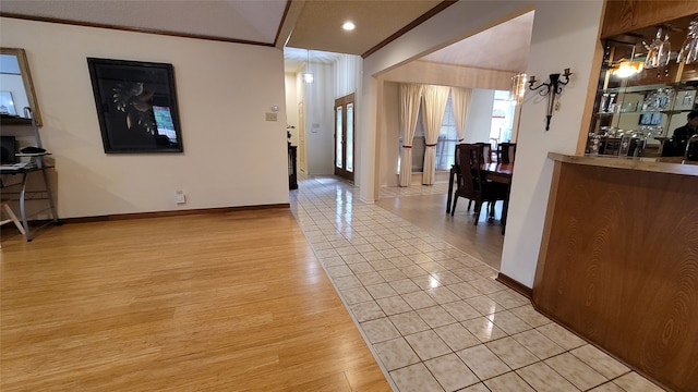 interior space featuring ornamental molding and light tile floors