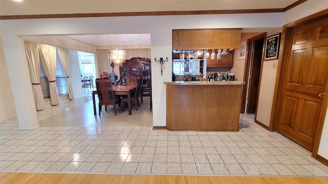 kitchen with a chandelier, decorative light fixtures, and light wood-type flooring