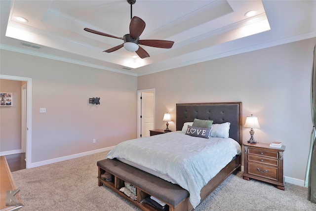 bedroom featuring ceiling fan, crown molding, a raised ceiling, and carpet flooring