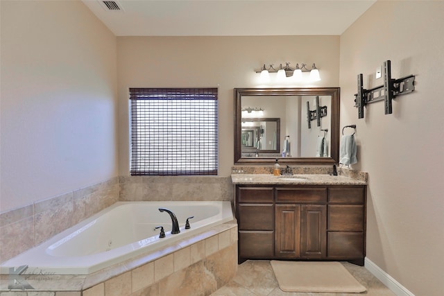 bathroom featuring tiled bath, oversized vanity, and tile flooring