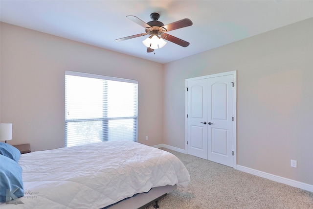 carpeted bedroom with a closet and ceiling fan