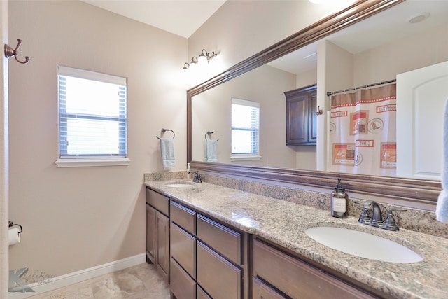 bathroom with tile flooring, double sink, and large vanity