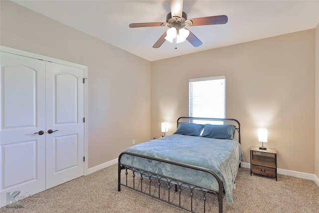 carpeted bedroom with a closet and ceiling fan