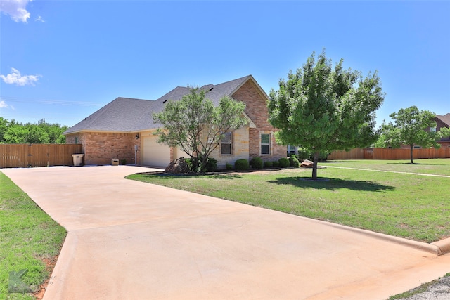 view of front facade with a garage and a front lawn