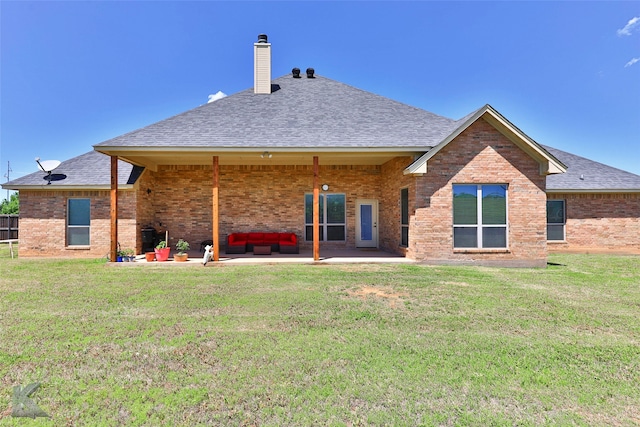 rear view of property featuring a patio and a yard