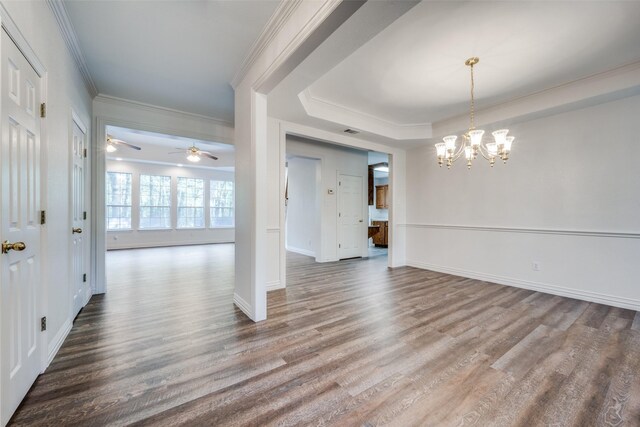 interior space featuring hardwood / wood-style flooring, ornamental molding, and ceiling fan with notable chandelier