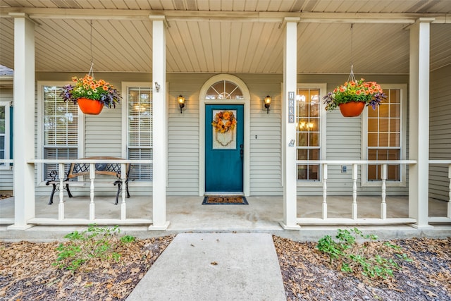 view of exterior entry with covered porch