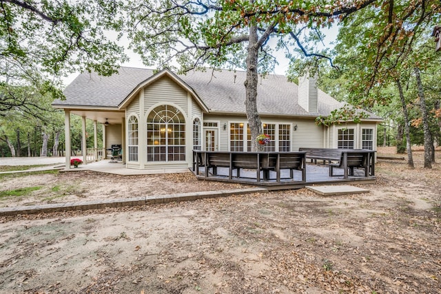 rear view of house featuring a deck, ceiling fan, and a patio area