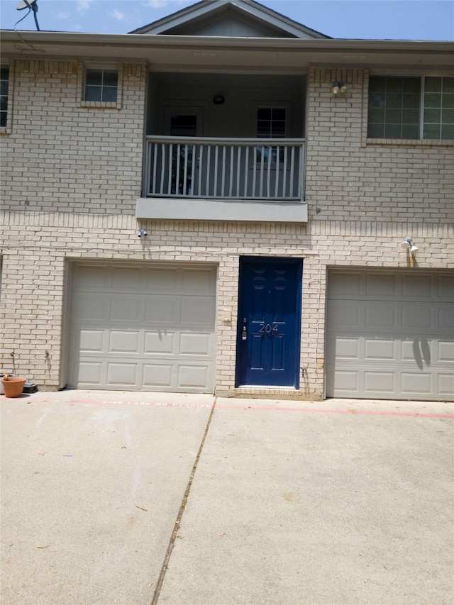 view of front of home with a garage and a balcony