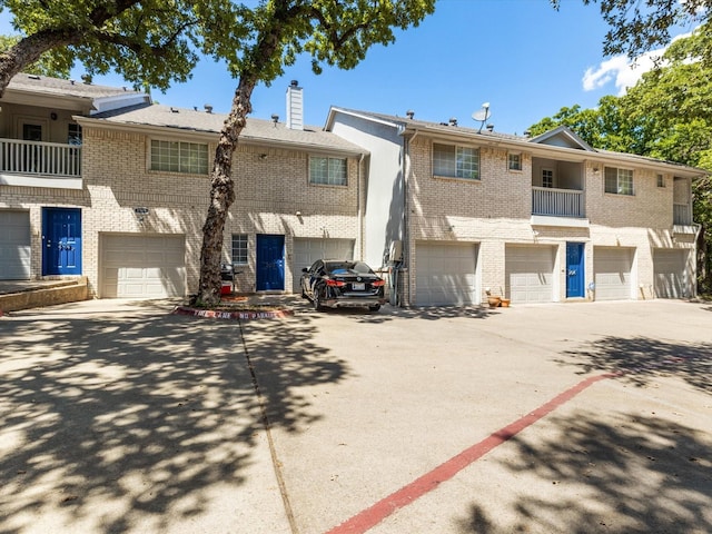 townhome / multi-family property featuring a garage and a balcony