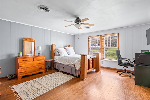 bedroom featuring wood-type flooring, ceiling fan, and crown molding