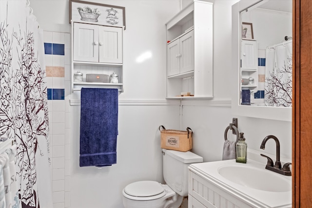 bathroom with toilet and large vanity