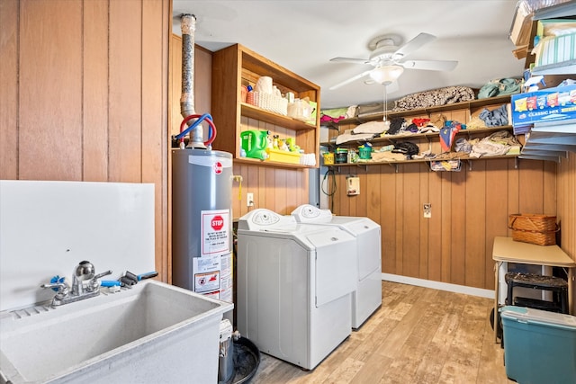 laundry room with gas water heater, independent washer and dryer, sink, light hardwood / wood-style floors, and ceiling fan