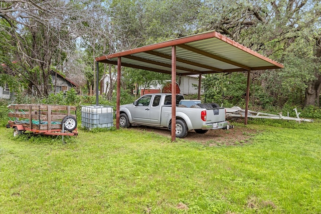 view of vehicle parking with a yard and a carport