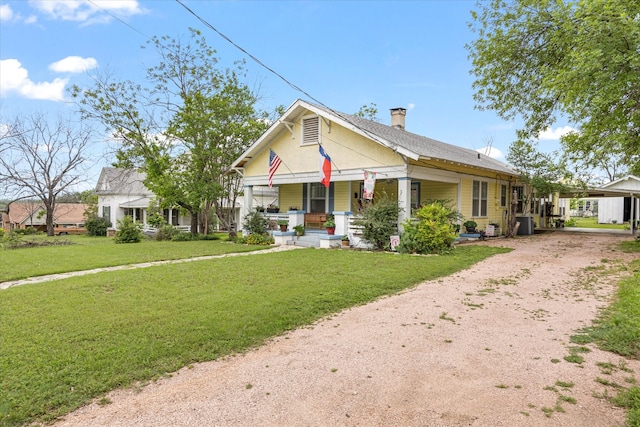 view of front of property with a front lawn and central AC unit