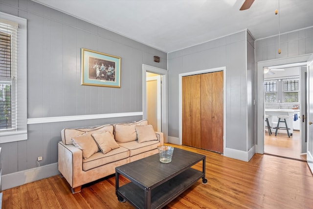 living room featuring plenty of natural light, ceiling fan, and hardwood / wood-style flooring