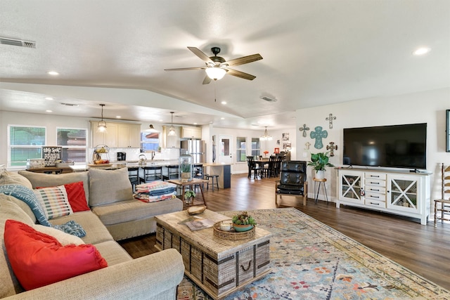 living room featuring ceiling fan, dark hardwood / wood-style flooring, and lofted ceiling