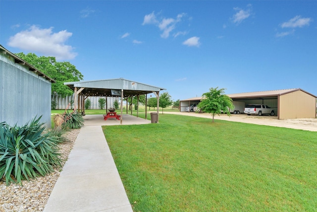 view of yard featuring an outdoor structure and a carport