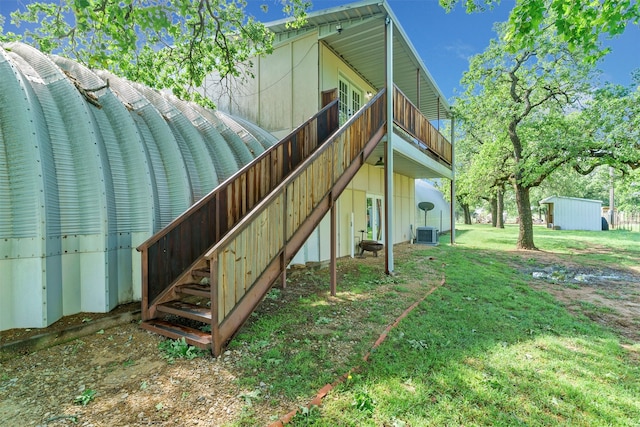 view of property exterior featuring a lawn and central AC unit