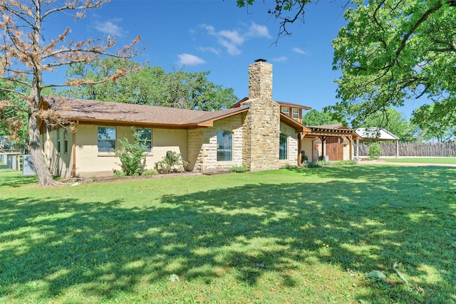 rear view of property featuring a yard