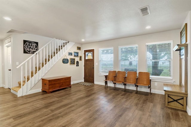 entrance foyer with hardwood / wood-style floors and a textured ceiling