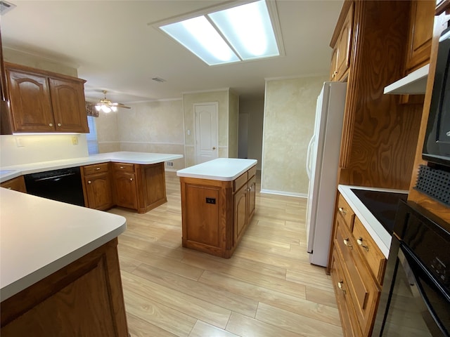 kitchen with light hardwood / wood-style flooring, a center island, ceiling fan, and black appliances