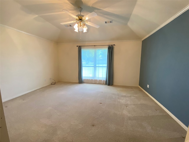 unfurnished room with carpet flooring, vaulted ceiling, crown molding, and ceiling fan