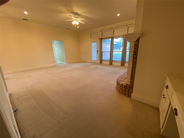 unfurnished bedroom featuring access to outside, ceiling fan, and light colored carpet