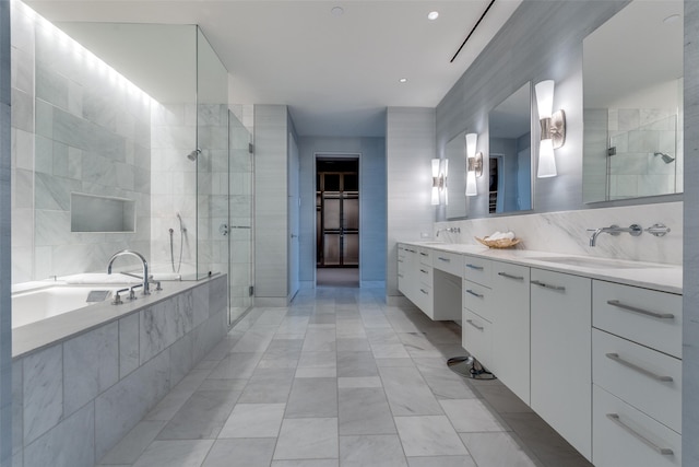 bathroom featuring tile walls, tile floors, dual bowl vanity, and shower with separate bathtub