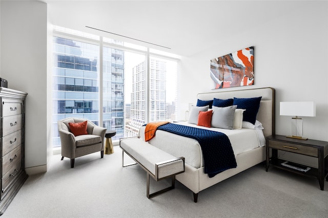 bedroom with a wall of windows, access to exterior, and carpet floors