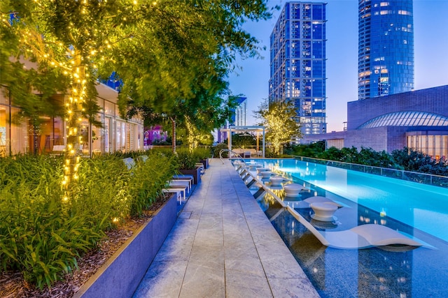 view of pool at dusk