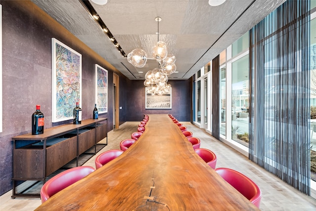 dining space with expansive windows and a chandelier