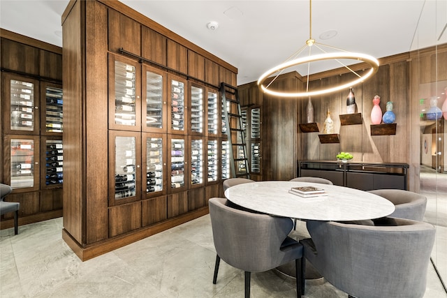 wine room with wood walls and light tile flooring