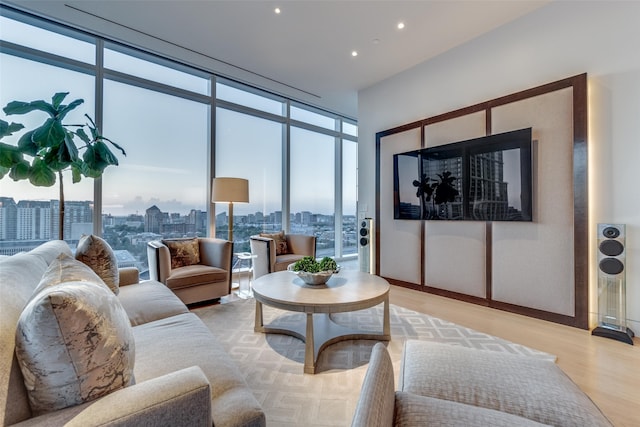 living room featuring a wall of windows and light wood-type flooring