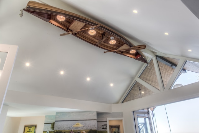 kitchen featuring vaulted ceiling, light hardwood / wood-style floors, an island with sink, and wooden walls