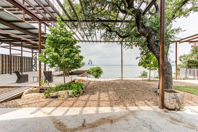 view of yard with a water view and a pergola