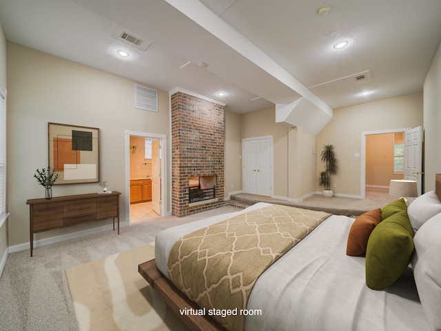 bedroom featuring a closet, light colored carpet, connected bathroom, and brick wall