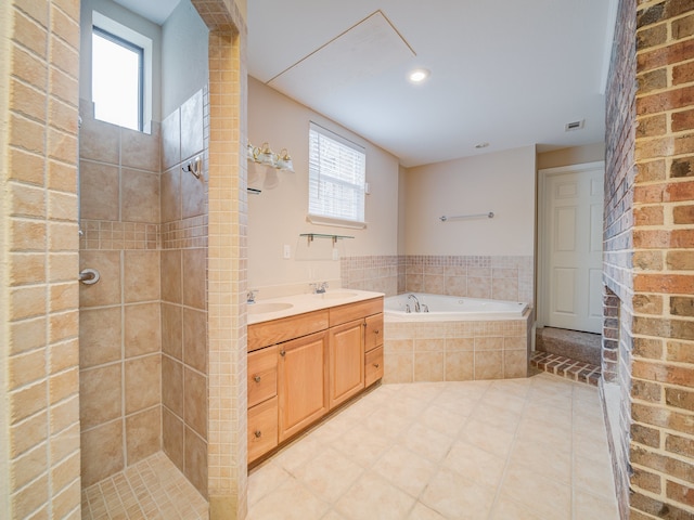 bathroom with brick wall, tile flooring, vanity, and independent shower and bath