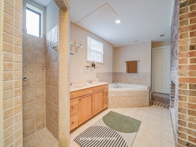 bathroom featuring tile flooring, brick wall, separate shower and tub, and vanity