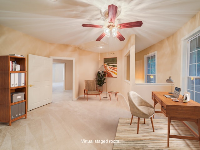 living area featuring carpet and ceiling fan