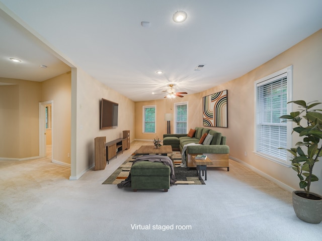 carpeted living room featuring ceiling fan