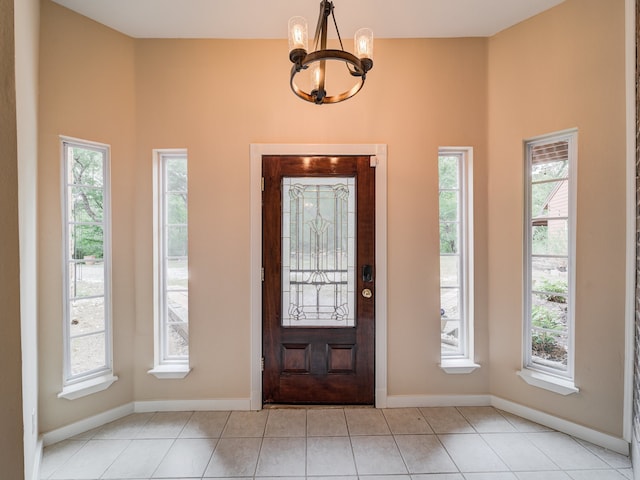 tiled entryway with an inviting chandelier and plenty of natural light