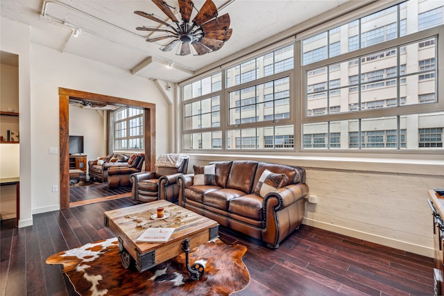 living room with ceiling fan, dark wood-type flooring, and track lighting