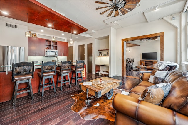 living room featuring ceiling fan, sink, dark hardwood / wood-style flooring, and track lighting