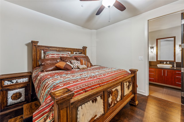 bedroom featuring sink, ceiling fan, ensuite bath, and dark hardwood / wood-style floors