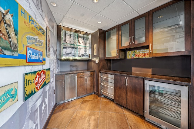 bar featuring a drop ceiling and wine cooler